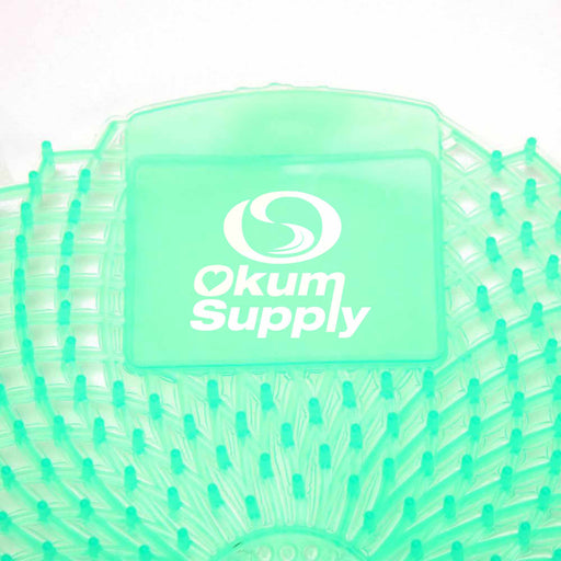 close up of Eclipse Urinal Screen in Light Green, Cucumber Melon Fragrance, with Okum Supply Logo